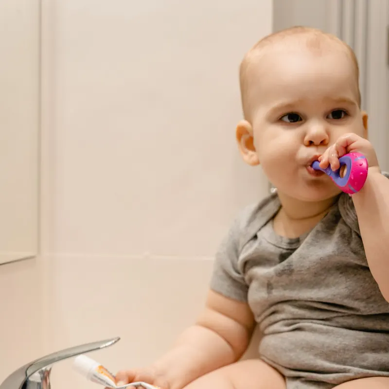 Child brushing teeth as part of dental aftercare